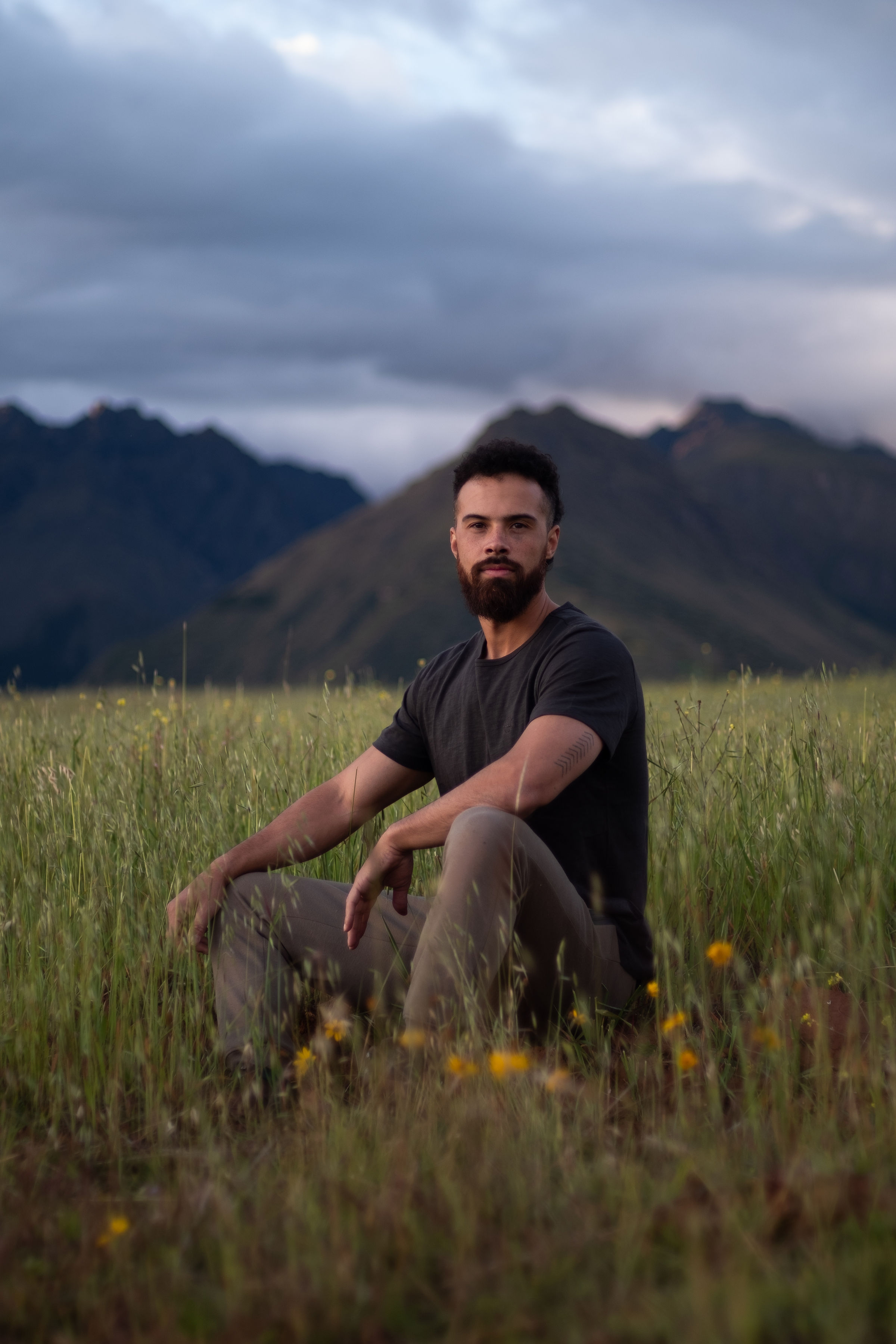 Jono Mitchell seated in a field in the Sacred Valley