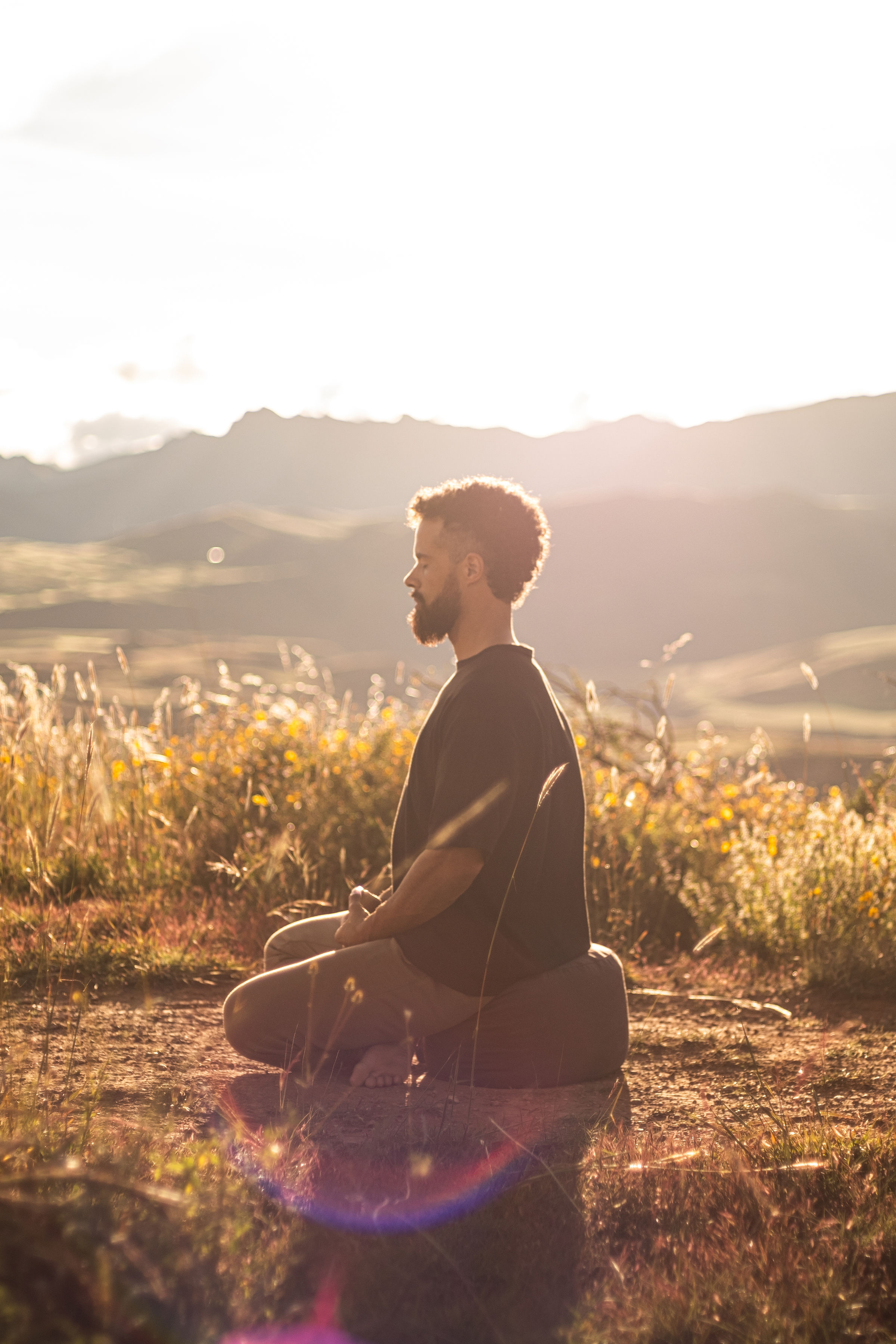 Jono Mitchell meditating outdoors in warm Sacred Valley light