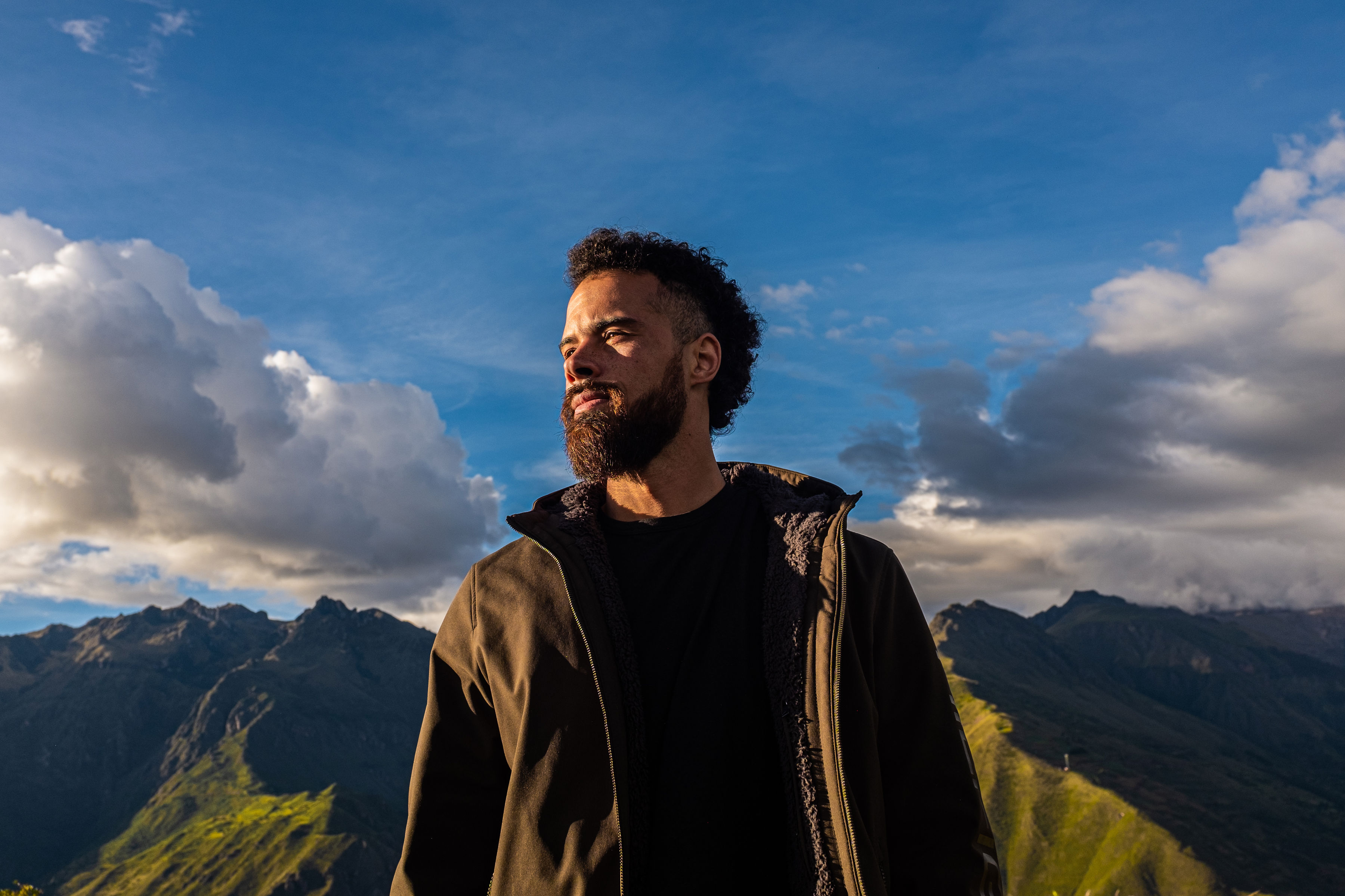 Jono Mitchell standing in the Andes beneath dramatic clouds