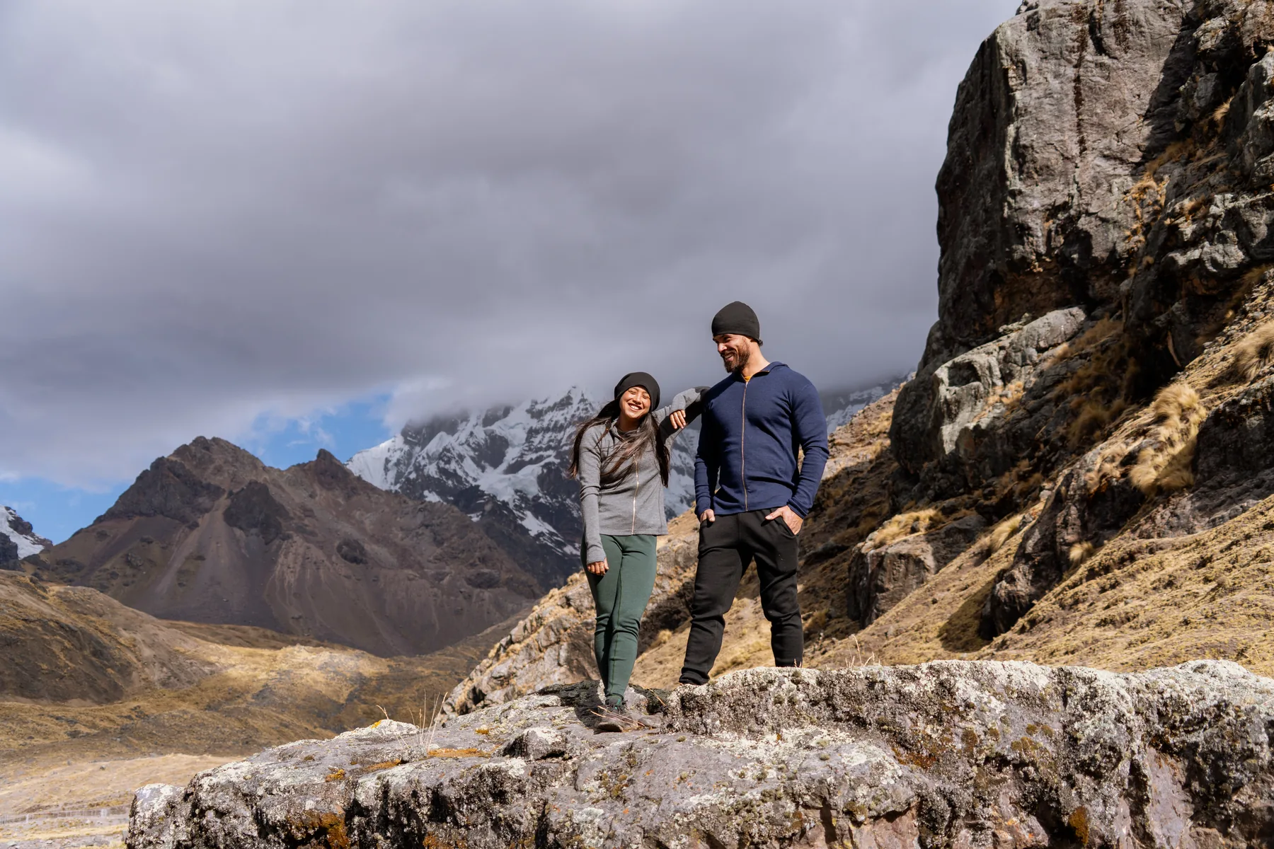 A couple beside a glacier river in the Andes