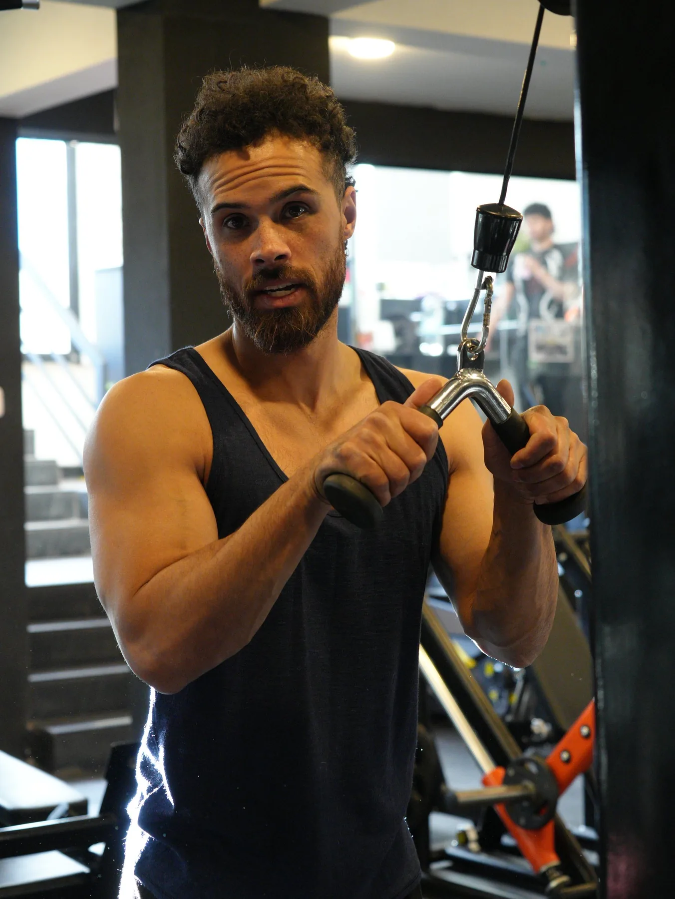 Jono Mitchell training in a black tank top at a Cusco gym