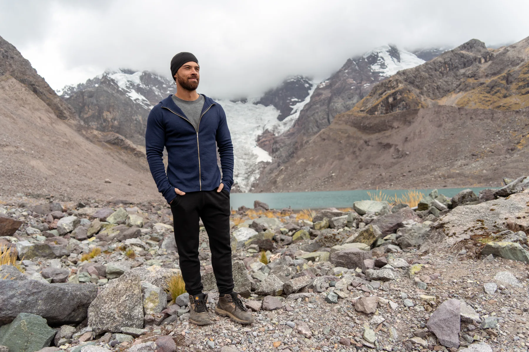 Jono Mitchell standing beside a glacier lake in the Andes