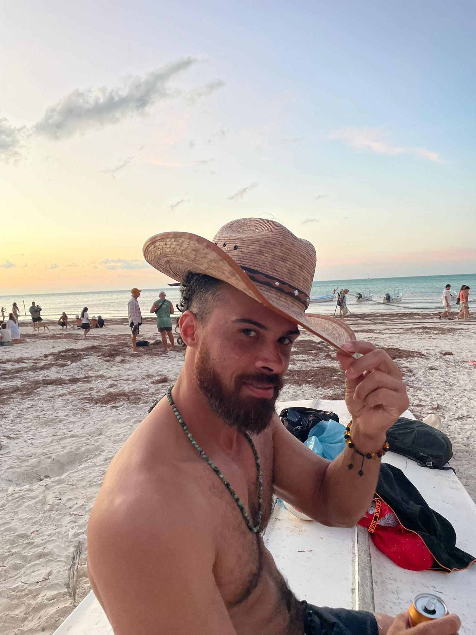 Jono Mitchell wearing a cowboy hat on the beach in Isla Holbox, Mexico