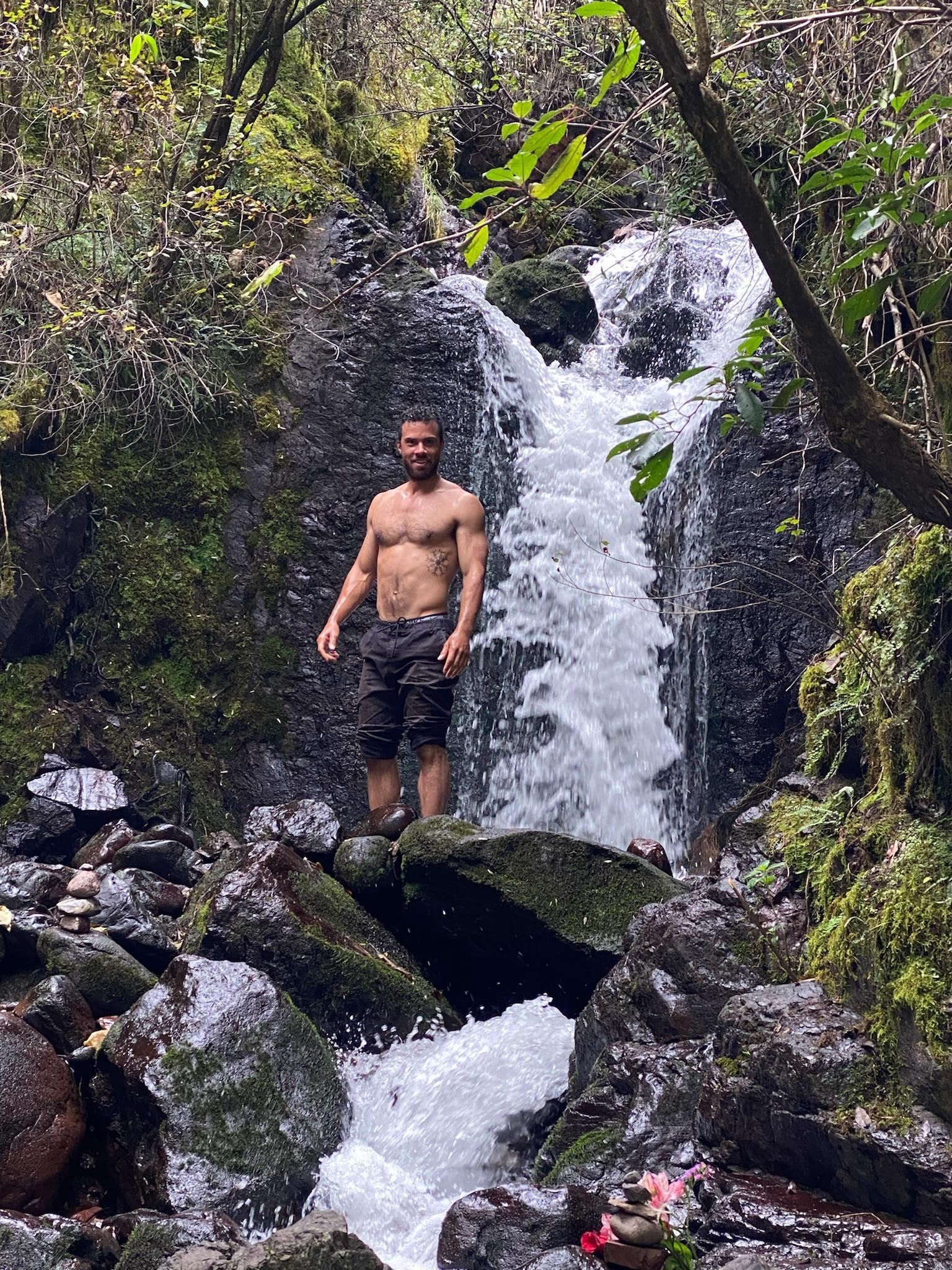 Jono Mitchell standing beside a Sacred Valley waterfall